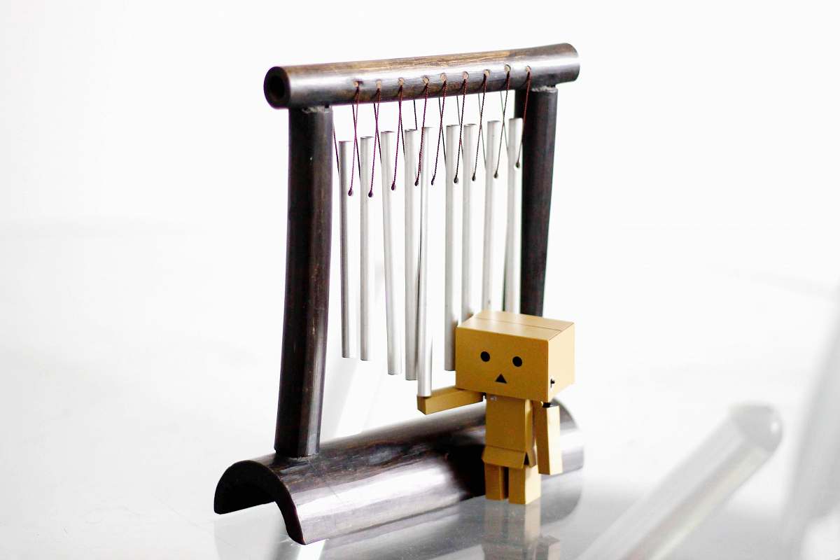 windchime danbo standing beside wind chimes chime